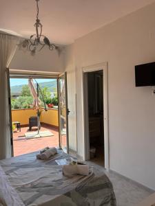 a bedroom with a bed and a view of a patio at La casa di Nonna Anna in Castellabate