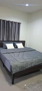 a bedroom with a bed with a metal headboard at TR Hotel Udon Thani in Ban Dong Kheng