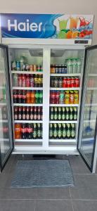 a refrigerator filled with lots of food and drinks at TR Hotel Udon Thani in Ban Dong Kheng