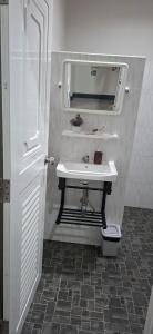a bathroom with a white sink and a mirror at TR Hotel Udon Thani in Ban Dong Kheng