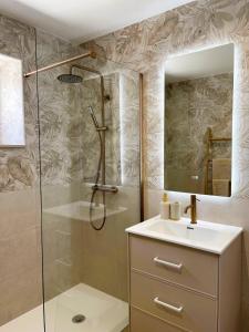 a bathroom with a shower and a sink and a mirror at Vila Sotto Mayor in Figueira da Foz +36 photos