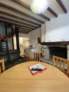 a dining room with a table and a living room at "Les Mouettes" Maison de pêcheur en centre ville in Saint-Vaast-la-Hougue