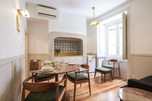 a kitchen and living room with a table and chairs at Pendoa Sintra Collection-Soft Opening in Sintra