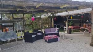 a group of couches and chairs under a tent at pastelle entre zoo et chateau in Contres +21 photos