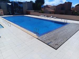 a large swimming pool with a pair of scissors on it at Bleu miami in Argelès-sur-Mer +6 photos