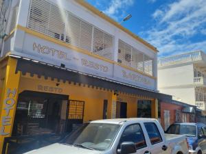 a hotel resko with cars parked in front of it at Hotel Bartaba in Antsiranana