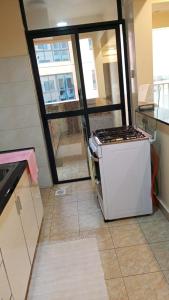 a kitchen with a stove in the middle of a room at Kaisa Studio apartments in Nairobi