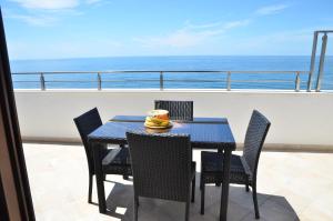 a table and chairs on a balcony with the ocean at Villa Marinero in Ulcinj