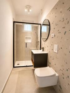 a bathroom with a toilet and a sink and a mirror at Apartments Marko in Vodice +27 photos