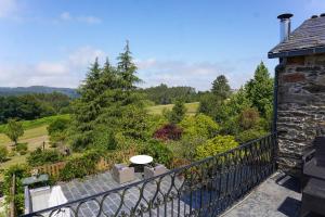 a balcony with a view of a garden at Casa Piñeiro in Monfero