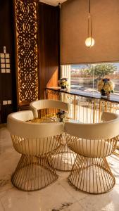 a room with two chairs and a table with a window at Qasr Arin Aprtments For Serviced Apartments شقق قصر ارين للشقق المخدومة in Jeddah