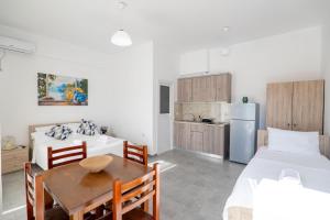 a kitchen and dining room with two beds and a table at Vila Antonio in Ksamil