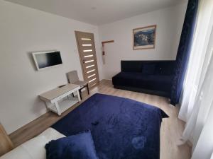a living room with a couch and a table at Privati valda in Šventoji