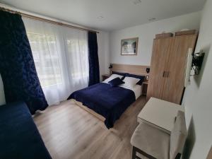 a small bedroom with a bed and a window at Privati valda in Šventoji
