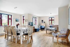 a dining room and living room with a table and chairs at LF13030-Karby-Agerovej-44 in Karby