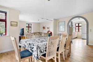 a dining room and kitchen with a table and chairs at LF13030-Karby-Agerovej-44 in Karby