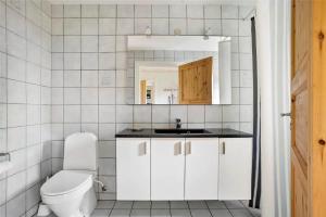 a white bathroom with a toilet and a sink at LF13030-Karby-Agerovej-44 in Karby +13 photos