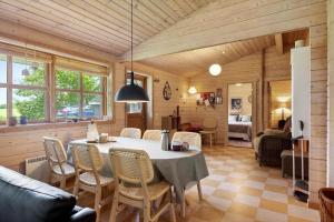 a dining room with a table and chairs at LF10999-Thyholm-Ringvejen-9 in Thyholm