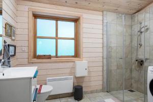 a bathroom with a toilet and a shower and a window at LF10999-Thyholm-Ringvejen-9 in Thyholm +17 photos