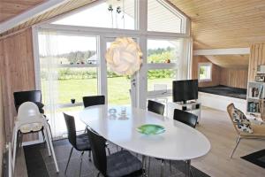a dining room with a white table and chairs at LF15018-Skals-Lynderup-Strand-4 in Skals