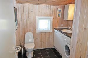 a small bathroom with a toilet and a sink at LF15018-Skals-Lynderup-Strand-4 in Skals +16 photos