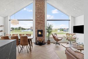a living room with a table and a fireplace at 391-Harboore-Slettevej-33 in Harboør
