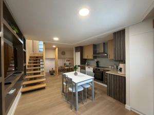 a kitchen with a table and chairs in a room at casa Angelita in Mourillones