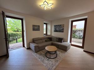 a living room with a couch and a table at Rosa dei Venti - Como Lake House in Valmadrera