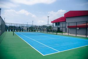 a tennis court in front of a building at Coconut Hotel And Pool in Gevgelija
