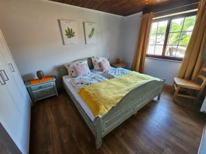 a bedroom with a bed and a chair in it at Fewo Eifel Dahlem Nationalpark Sonnenterrasse & Kamin in Dahlem