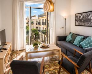 a living room with a couch and a table at Apartamentos Turísticos Teatro Romano by CartagenaSpain in Cartagena