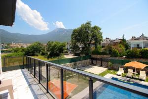 a house with a balcony with a view of a mountain at Villa Prestige 2 in Fethiye