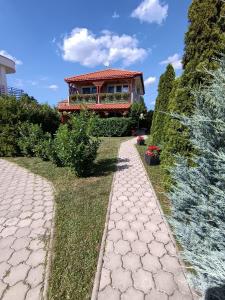 a house with a walkway in front of a house at Riviera Apartman in Hajdúszoboszló