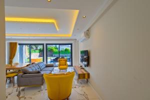 a living room with a couch and a table at Villa Prestige 2 in Fethiye