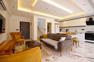 a living room with a couch and a table at Villa Prestige 2 in Fethiye