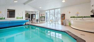 a large bathroom with a tub and a large swimming pool at LF391-Vestervig-Gunhildsvej-1 in Vestervig