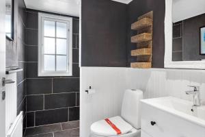 a bathroom with a white toilet and a sink at LF391-Vestervig-Gunhildsvej-1 in Vestervig +17 photos