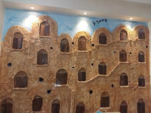 a building with a bunch of windows on the wall at Hôtel Matous in Tunis