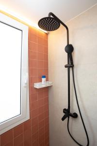a shower with a shower head in a bathroom at Apartamentos San Antonio Beach in San Antonio Bay