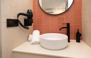 a bathroom with a sink and a mirror at Apartamentos San Antonio Beach in San Antonio Bay