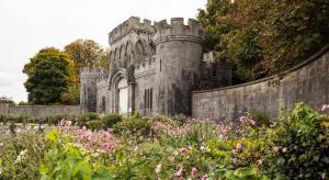 an old castle with a garden and flowers at Market Square in Monasterevin