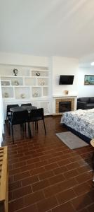 a bedroom with a table and a bed and a television at Villa Golden Coast - Lagos in Lagos