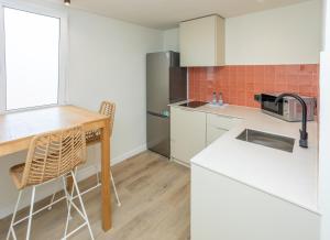 a kitchen with a table and a counter top at Apartamentos San Antonio Beach in San Antonio Bay +125 photos