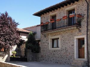 a stone house with two balconies on a building at Casa del Tío Benito 2H in Molinos de Duero