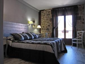 a bedroom with a large bed and a window at Casa del Tío Benito 2H in Molinos de Duero