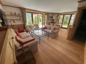 a living room with two couches and a table at 2,5 Zimmer Wohnung mit Bergblick in Engadin in Zuoz +41 photos