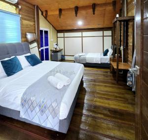 a bedroom with two beds with towels on it at PULANG RESORT in Setiu +82 photos