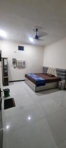 a bedroom with a bed in the middle of a room at Anusthan Hotel in Ūnchāhar
