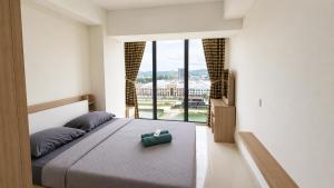 a bedroom with a bed and a large window at SleepRest @ Pollux Habibie in Batam Center +280 photos