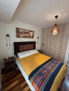 a bedroom with a bed and a chandelier at HOSPEDAJE HUIT STAr in Buenos Aires